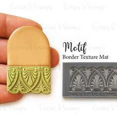 a hand holding a rubber stamp that says motif border texture mat with an ornate design on it