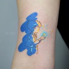 a blue and yellow bear tattoo on the ankle with an orange fire extinguisher