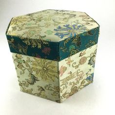 an open box with designs on it sitting on a white surface