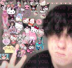 a man with black hair and lots of hello kitty stickers on his face in front of a wall