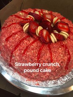 a strawberry crunch pound cake with chocolate drizzle and strawberries on the top