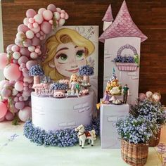 there is a cake that looks like a castle with princesses on it and balloons in the background