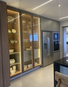 a modern kitchen with stainless steel appliances and cabinets