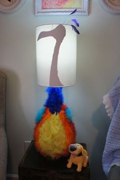 a lamp that is on top of a night stand with a stuffed animal next to it