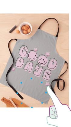 an apron with the words good days printed on it next to some eggs and utensils