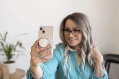 a woman taking a selfie with her cell phone