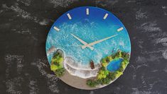 a clock that is made to look like the ocean with trees and rocks around it