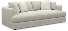 a white couch with pillows on it and two pillowed backrests in the middle