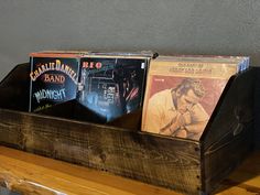 a wooden shelf with cd's on top of it