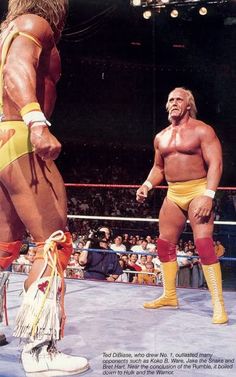 two men standing next to each other in a wrestling ring