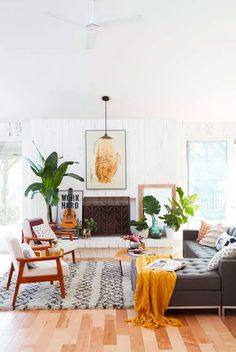 a living room filled with furniture and a fire place in the middle of the room