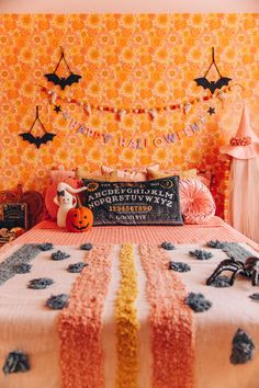 a bedroom decorated for halloween with decorations on the wall