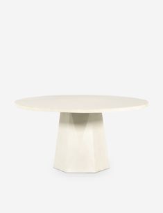 a white table with an oval shape on the top and two small circular bases at the base