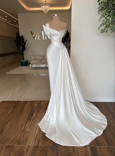 a white wedding dress on display in a room