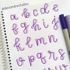 the letters and numbers are written in cursive writing on a notepad with a purple pen
