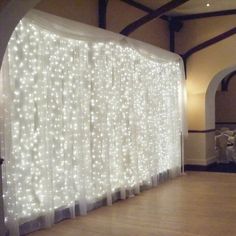 a white curtain with lights on it in front of a wall that says ebay