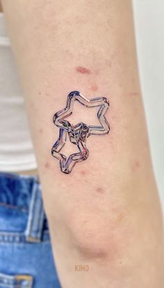 a woman's arm with a star tattoo on it