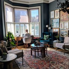 a living room filled with furniture and lots of windows