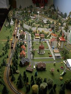 a model train set with buildings and trees