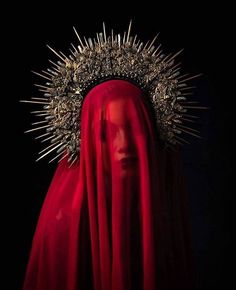 a woman with red veil and crown on her head