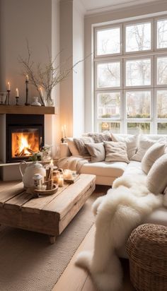 a living room filled with furniture and a fire place in front of a large window