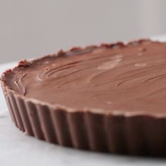 a chocolate pie sitting on top of a white table