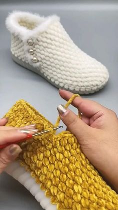 someone is crocheting the bottom part of a pair of slippers