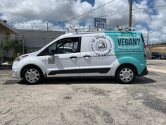 a van parked in a parking lot with the words vegan on it's side