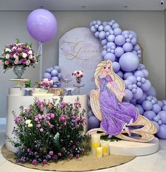 there is a table with flowers and balloons in the background that have been set up for a princess themed birthday party