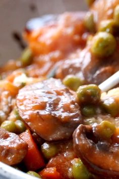 a bowl filled with meat and vegetables on top of a table