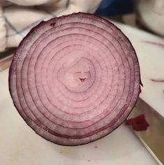 an onion is cut in half on a cutting board