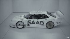 a white race car with the word saab painted on it's side in black and white