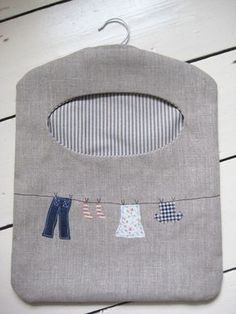 a baby's bib with clothes hanging from it