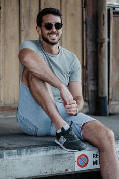 a man sitting on top of a cement step