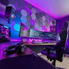 a gaming room with purple lighting and large monitors on the wall, along with headphones