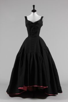 a black dress with red trims on the skirt