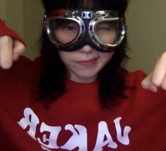 a woman wearing goggles and a red shirt