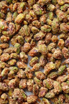 the nuts are covered in sugar and sprinkled with pistachios on top