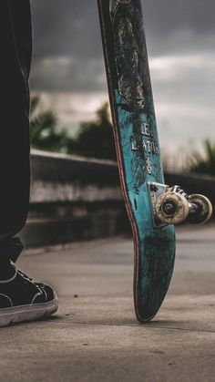 a person standing with their foot on a skateboard