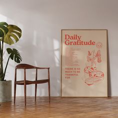 a chair sitting next to a plant in a room with a poster on the wall