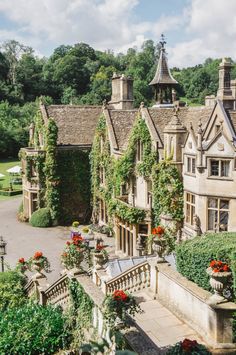 an aerial view of a large house with flowers growing on it