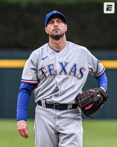 a baseball player standing on top of a field wearing a catcher's mitt