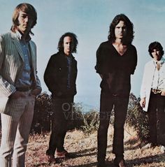 the rolling stones standing on top of a hill