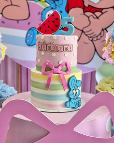 a birthday cake decorated with cartoon characters on it