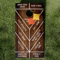 a wooden sign with different types of drinks on it in the middle of some grass