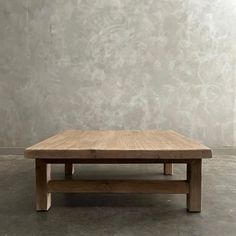 a wooden table sitting on top of a cement floor