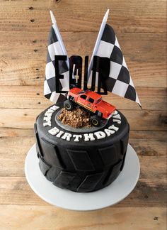 a black and white cake with a red truck on top