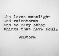 an old typewriter with the words, she loves moonlight and rains and so many other things that have soul