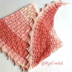 two crocheted shawls are sitting next to each other on a white surface