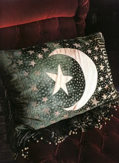 a green pillow with a white star and crescent on it